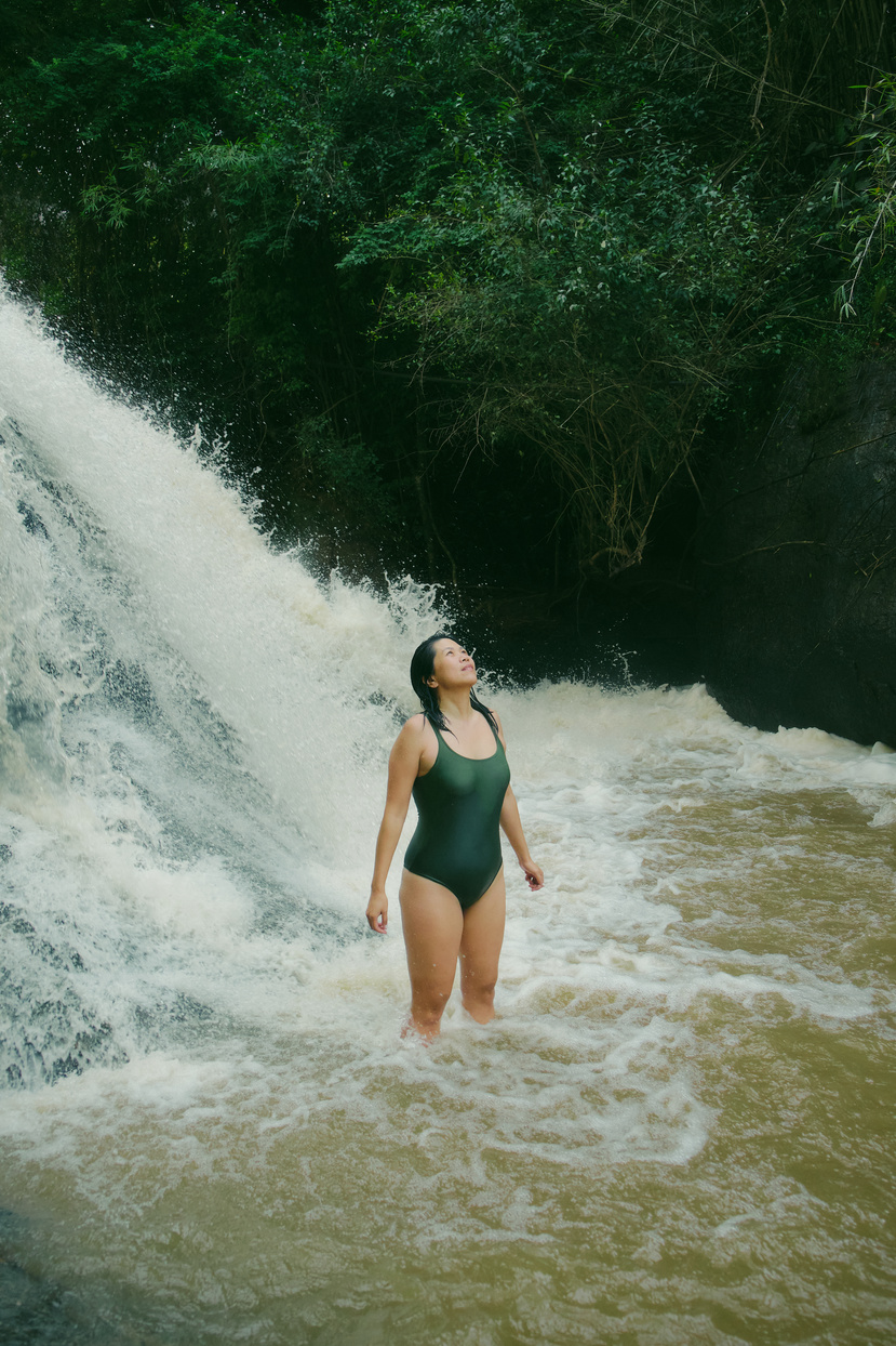 Travel: Tree Climbing Woman in Swimsuit by a Waterfall